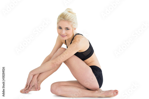Toned woman sitting over white background