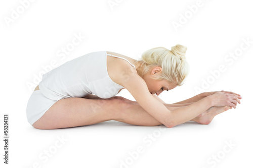 Toned young woman doing the paschimottanasana pose