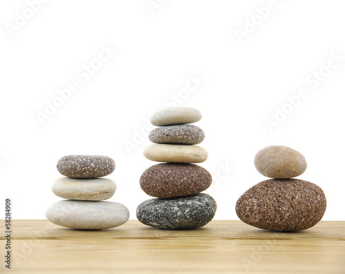 Three stacked stones on a wood board