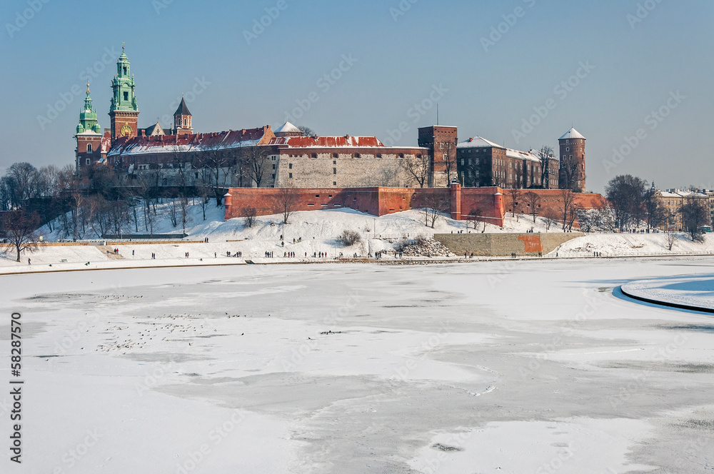Fototapeta premium Wawel Castle in Krakow and frozen Vistula river in winter