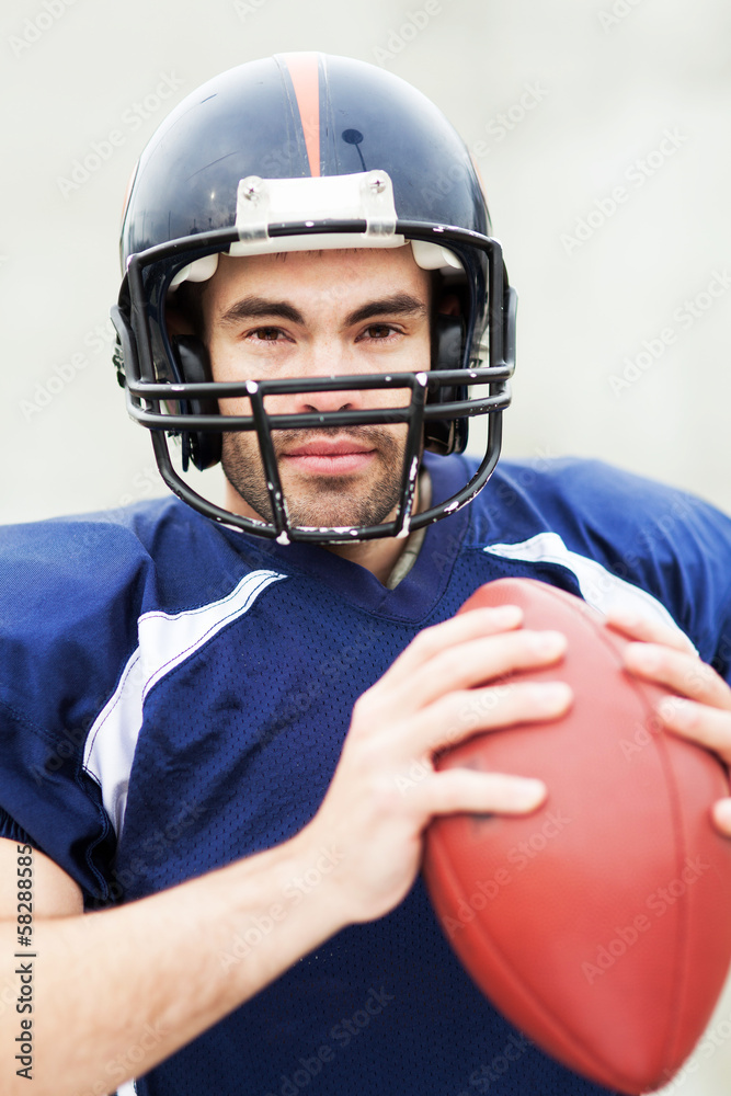 American footballer holding ball American footballer holding ball