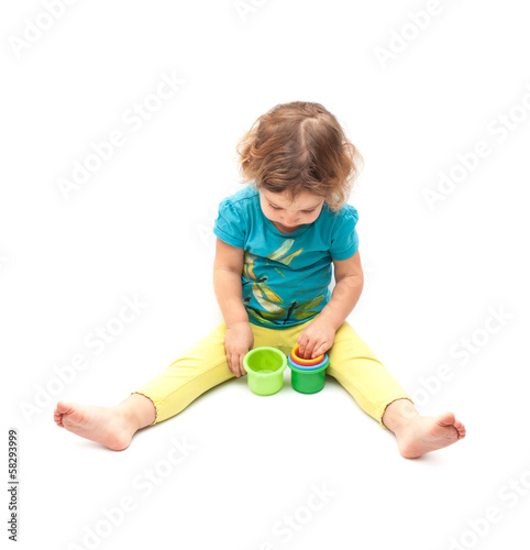 Little kid playing alone on white background