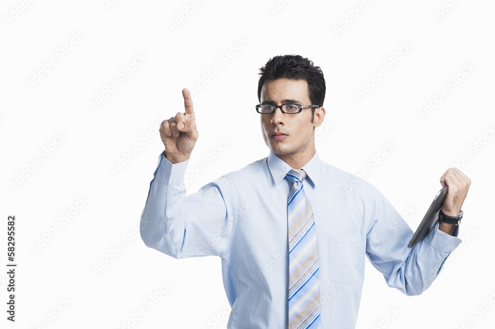Businessman touching a visual screen and holding a digital tablet Businessman touching a visual screen and holding a digital tablet