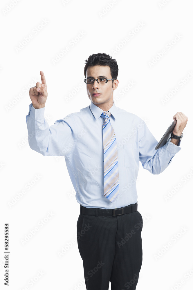Businessman touching a visual screen and holding a digital tablet Businessman touching a visual screen and holding a digital tablet