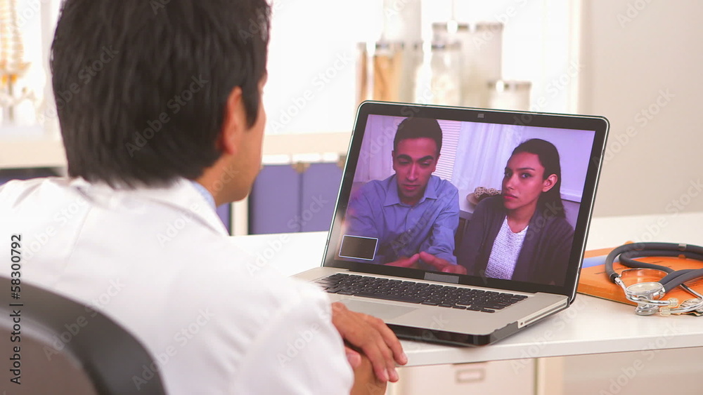 Mexican couple talking to doctor through video chat Mexican couple talking to doctor through video chat