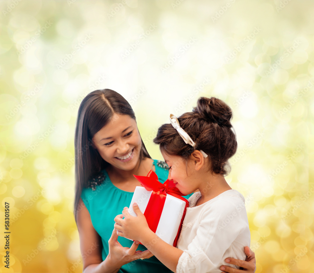 happy mother and child girl with gift box happy mother and child girl with gift box