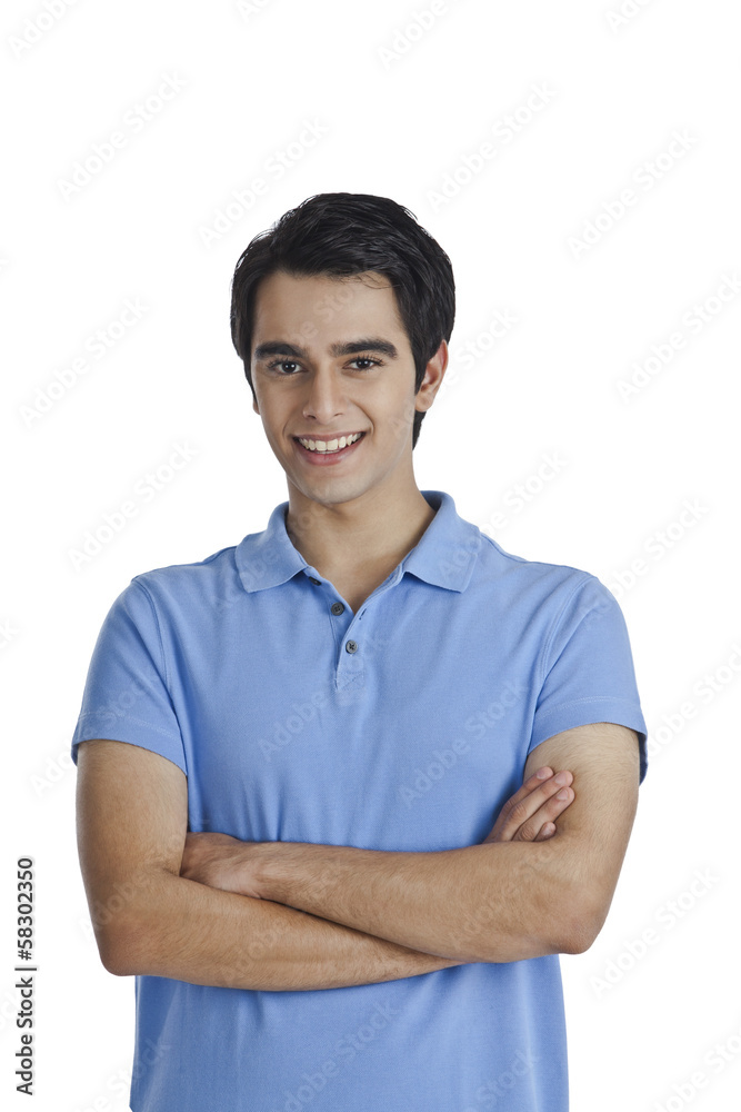 Man standing with his arms crossed and smiling Man standing with his arms crossed and smiling