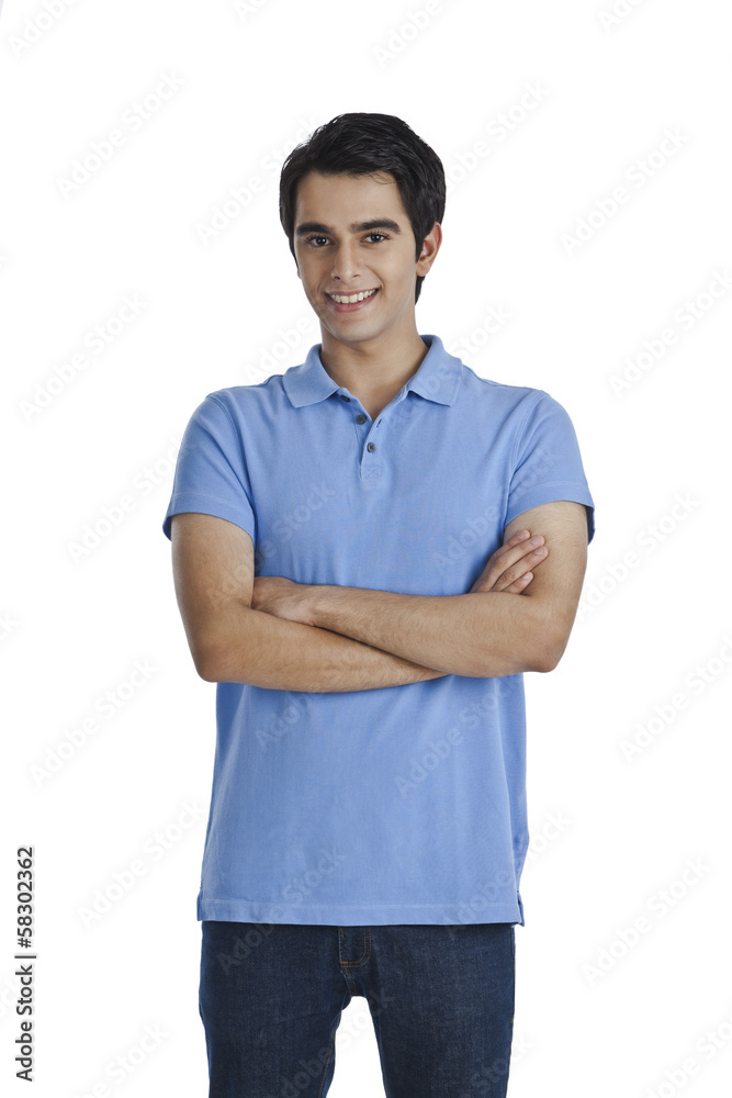Man standing with his arms crossed and smiling Man standing with his arms crossed and smiling