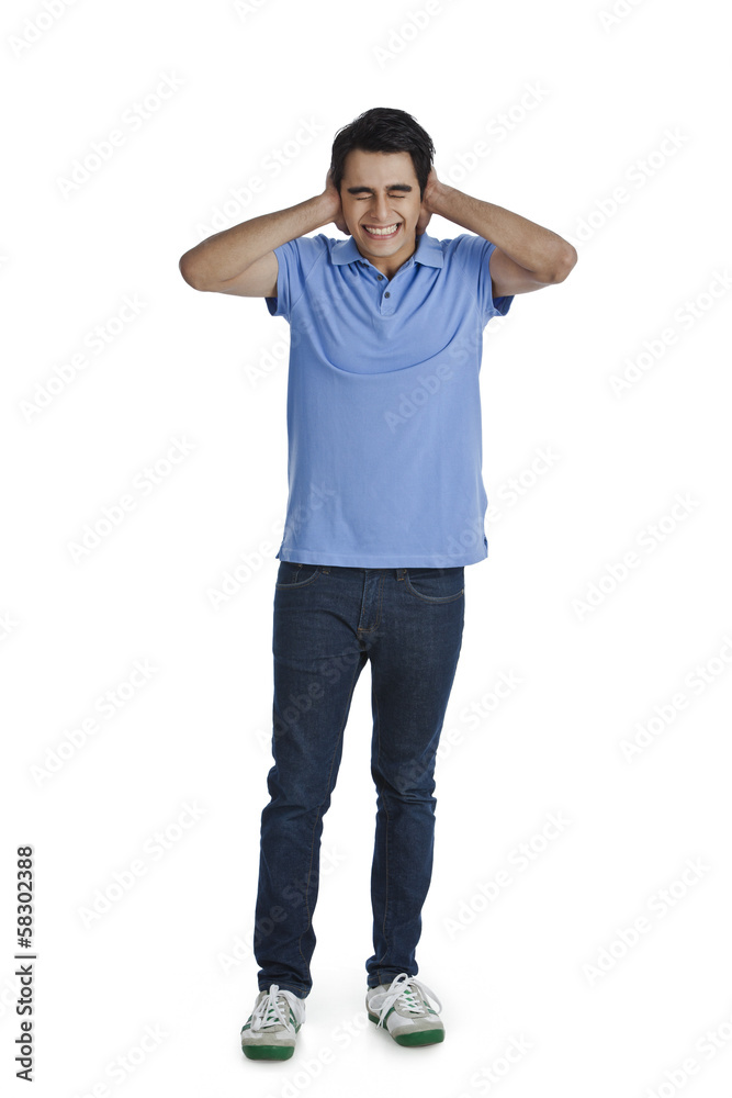 Man covering his ears with his hands Man covering his ears with his hands