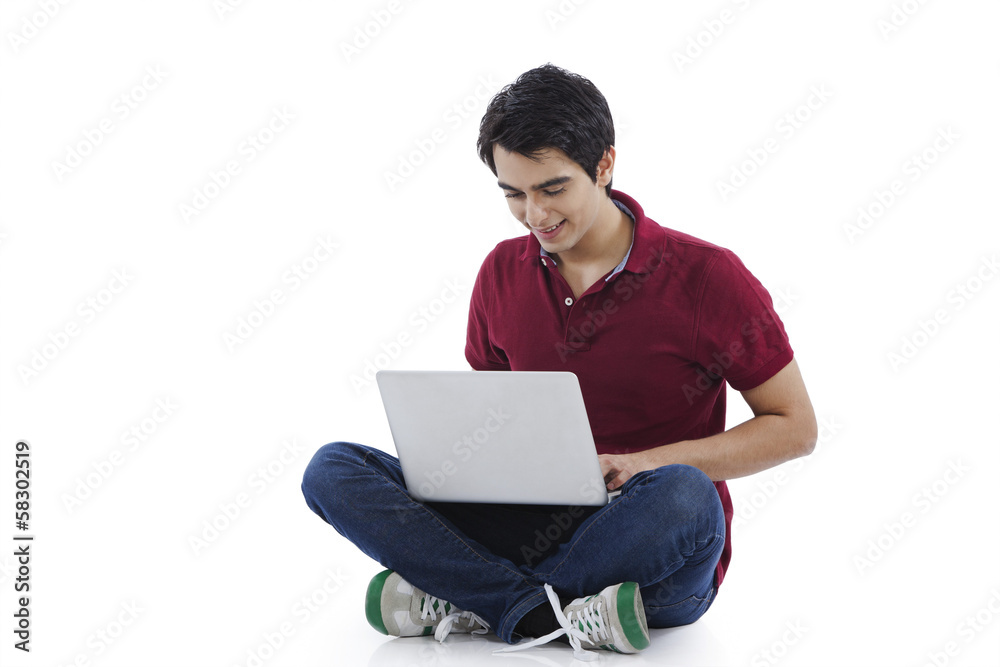 Man sitting on the floor and using a laptop Man sitting on the floor and using a laptop