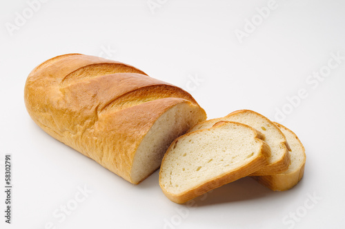 A piece of traditional Ukrainian white bread called "baton" with three cut slices