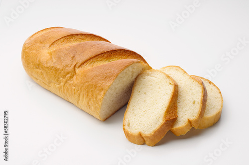 A piece of traditional Ukrainian white bread called "baton" with three cut slices