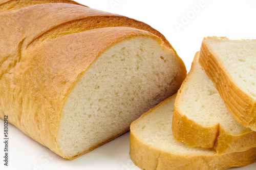 Detail of a piece of traditional Ukrainian white bread, called "baton" with three cut slices