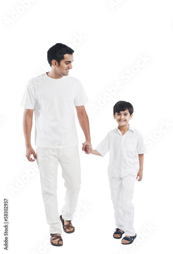 Happy father and son holding hands