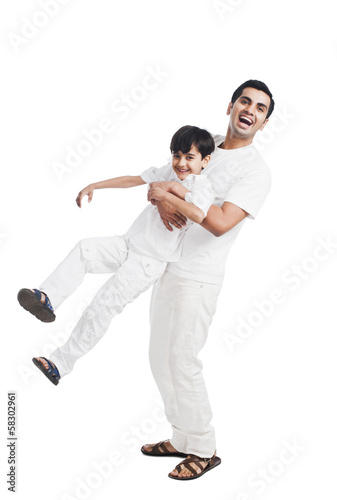 Happy father playing with his son