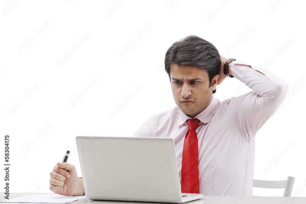 Businessman using a laptop and looking shocked Businessman using a laptop and looking shocked