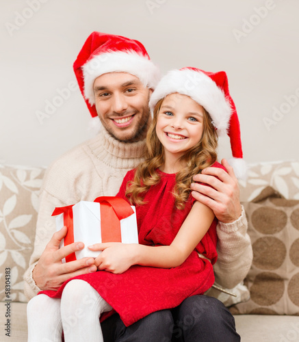 smiling father and daughter holding gift box