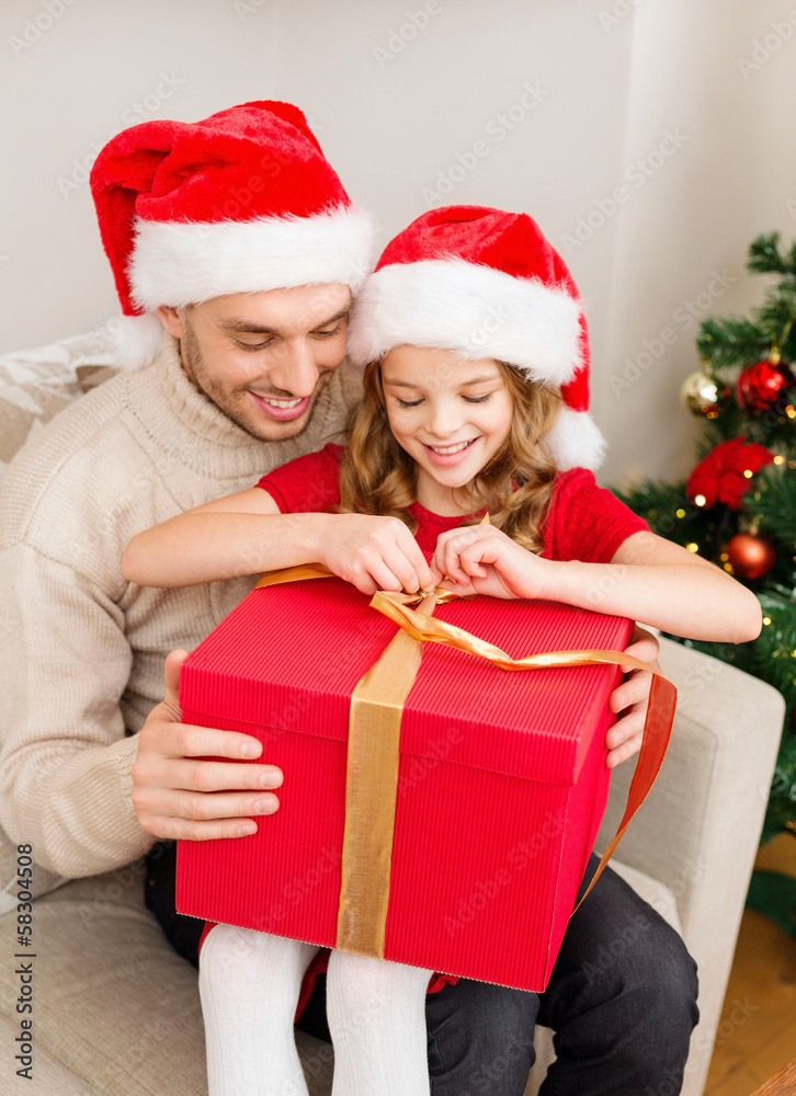 smiling father and daughter opening gift box smiling father and daughter opening gift box