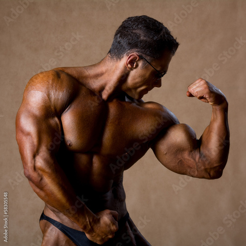Portrait of sexy muscle man posing in studio.