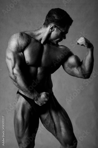 Portrait of sexy muscle man posing in studio. Bodybuilder demons