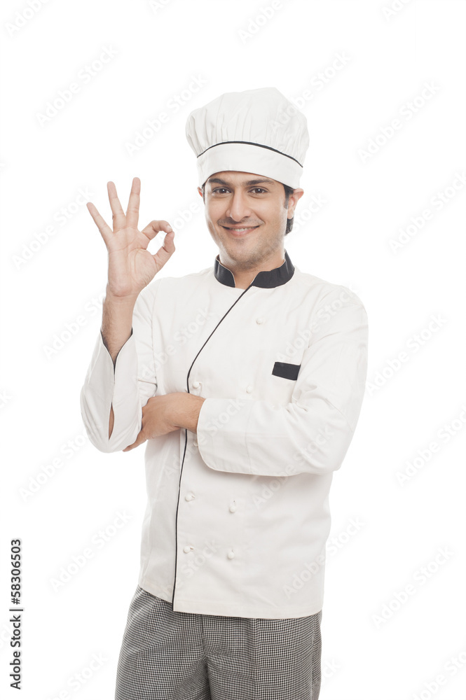 Portrait of a male chef showing ok sign and smiling