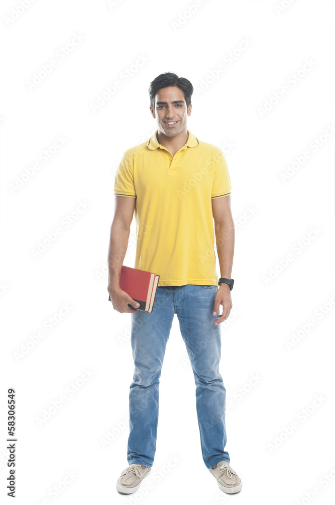 Portrait of an university student holding books and smiling Portrait of an university student holding books and smiling