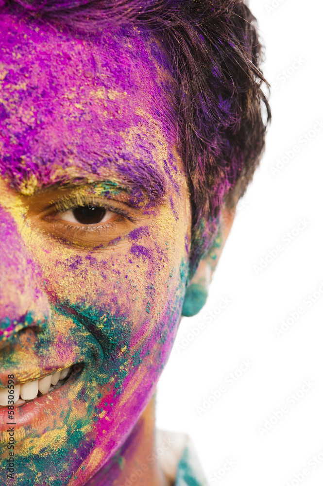 Mans face covered with powder paint during Holi festival Mans face covered with powder paint during Holi festival