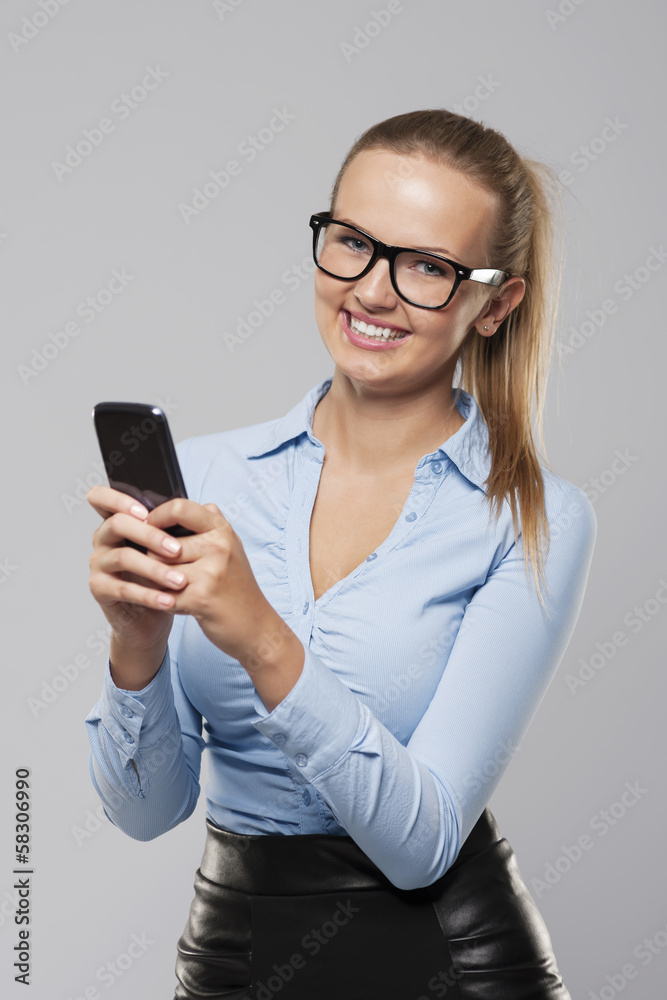 Beautiful blonde businesswoman with mobile phone