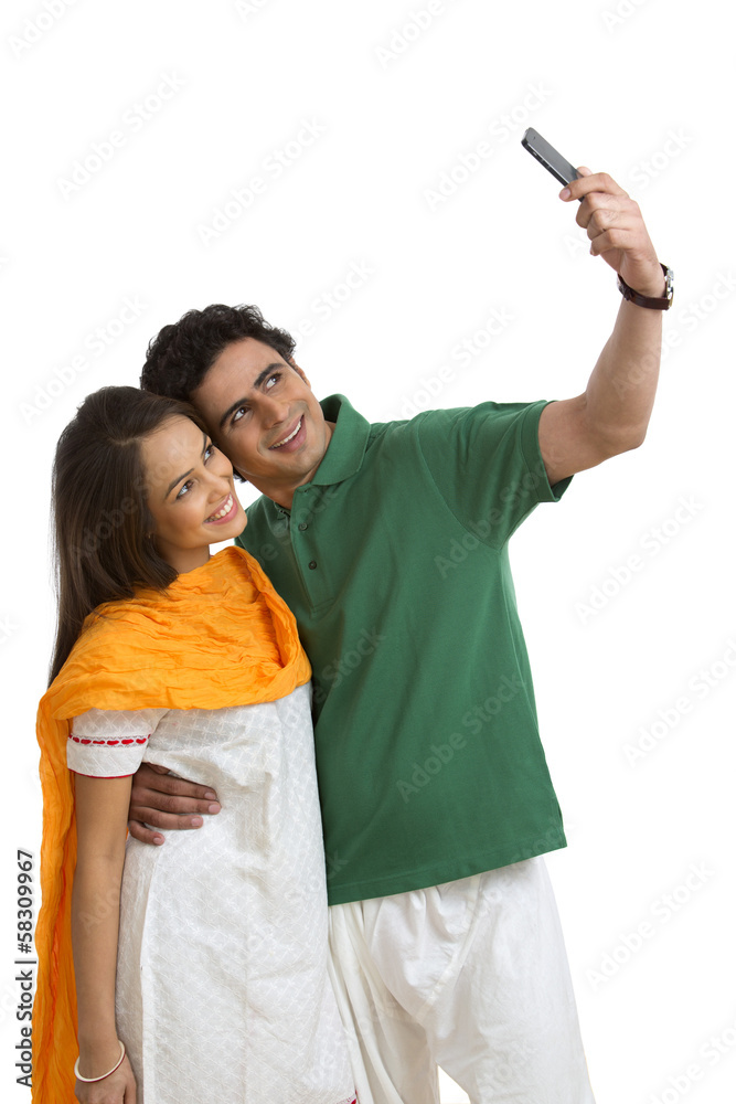 Couple taking a picture of themselves with a mobile phone Couple taking a picture of themselves with a mobile phone