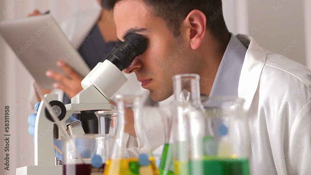 Mexican scientist doing research with colleague Mexican scientist doing research with colleague
