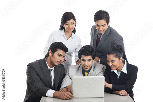 Business executives looking at a laptop