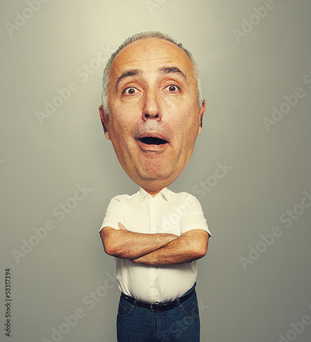 amazed bighead man over grey background