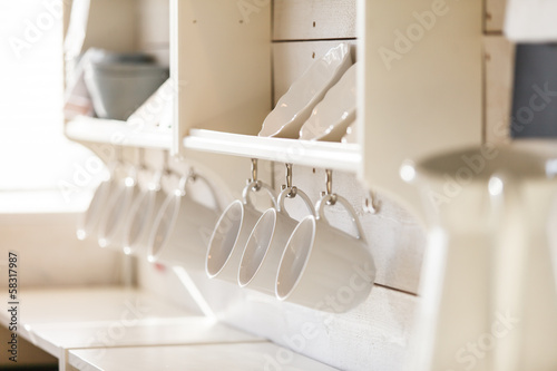 opened cupboard with kitchenware inside © Maksim Shebeko