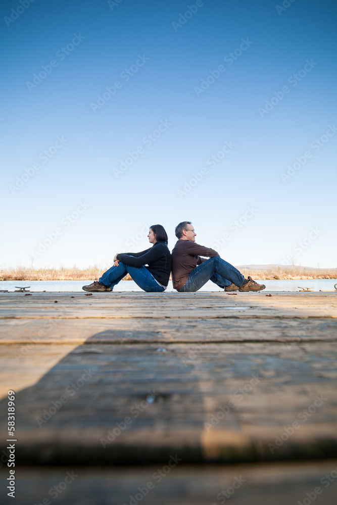 Couple sitting near water