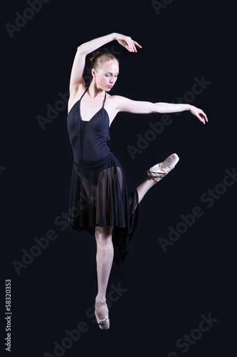 Ballet dancer in black dress isolated on gray background