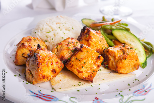 Zesty Chicken Shish Kebabs served on a Lavash Bread with rice Pi