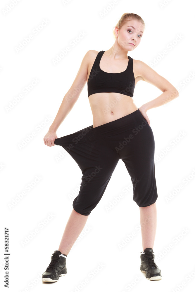 happy woman showing how much weight she lost, big pants happy woman showing how much weight she lost, big pants