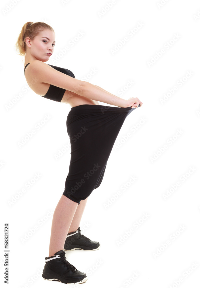 happy woman showing how much weight she lost, big pants happy woman showing how much weight she lost, big pants