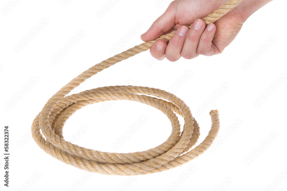 A roll of thick strong rope and the end of a man's hand.