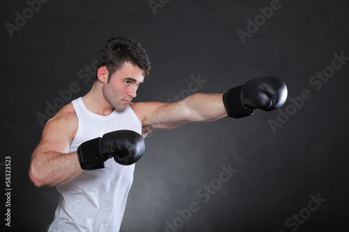 Portrait sportsman boxer in studio dark background © anetlanda