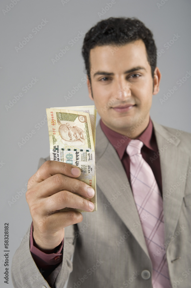 Businessman holding Indian five hundred rupee banknotes Businessman holding Indian five hundred rupee banknotes