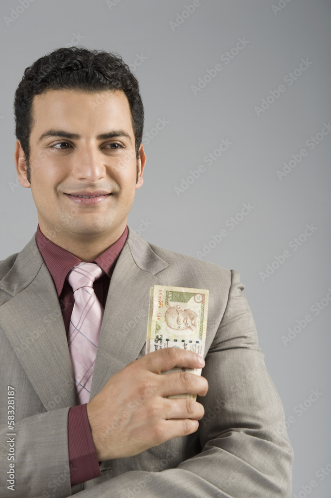 Businessman holding Indian five hundred rupee banknotes Businessman holding Indian five hundred rupee banknotes