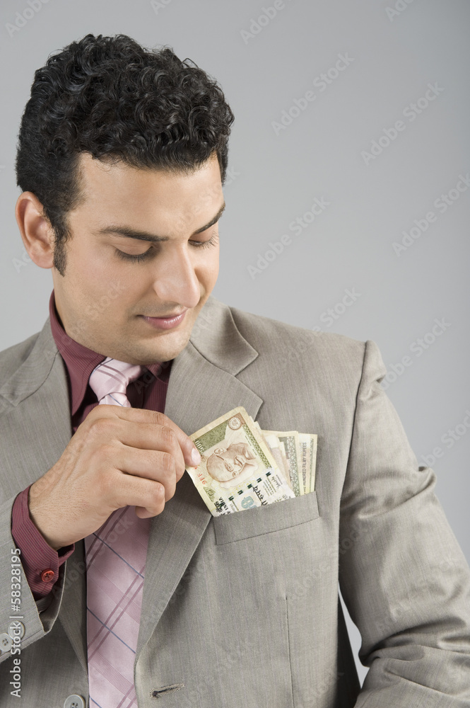 Businessman with Indian five hundred rupee banknotes in his pocket Businessman with Indian five hundred rupee banknotes in his pocket