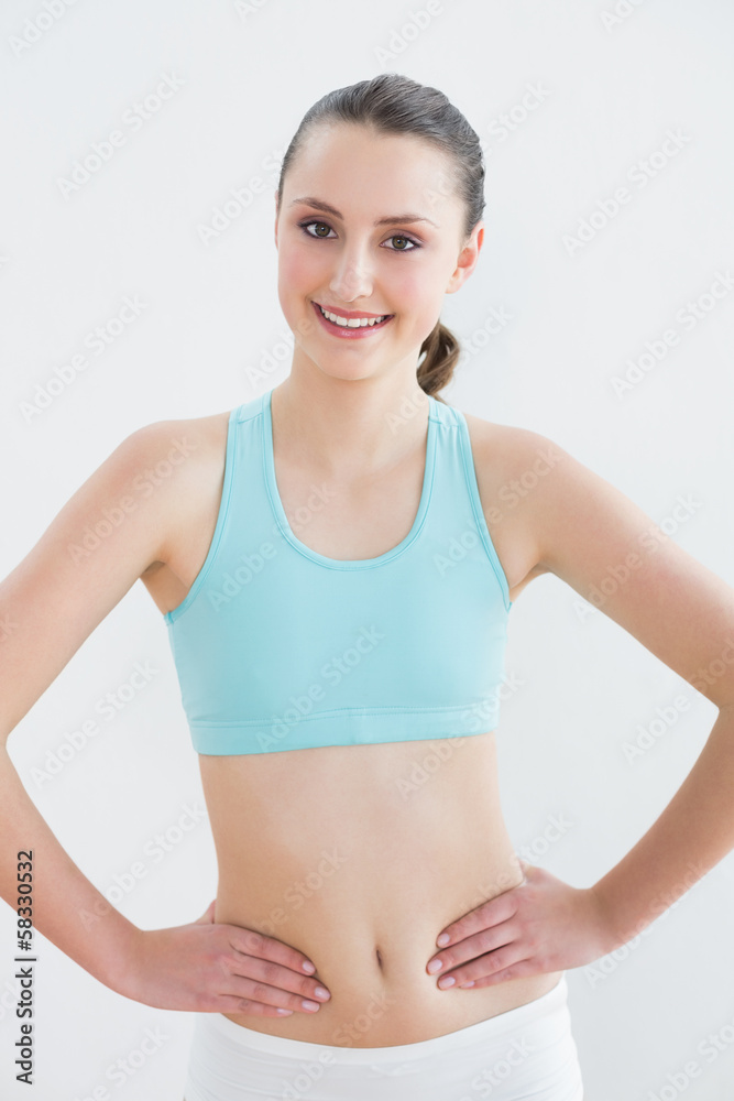 Smiling toned woman in fitness studio Smiling toned woman in fitness studio
