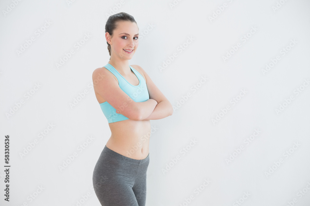 Portrait of toned woman against wall Portrait of toned woman against wall