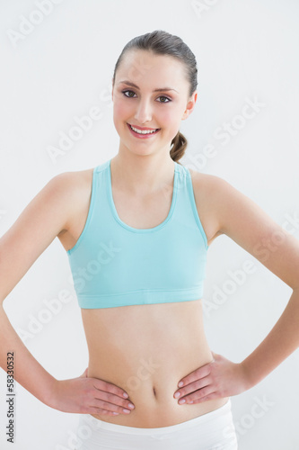 Smiling toned woman in fitness studio