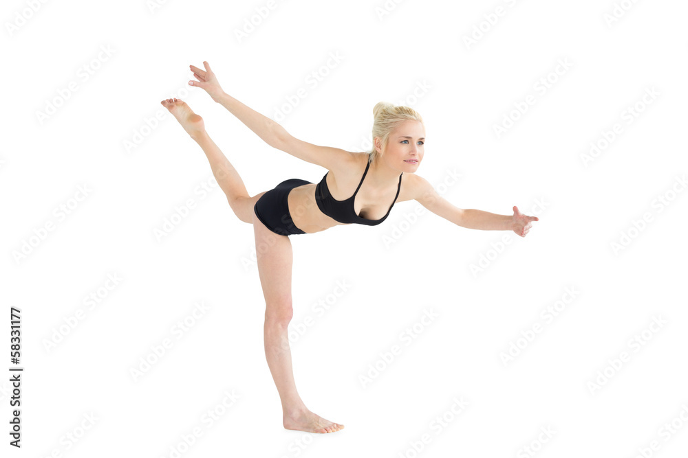 Sporty young woman balancing on one leg Sporty young woman balancing on one leg
