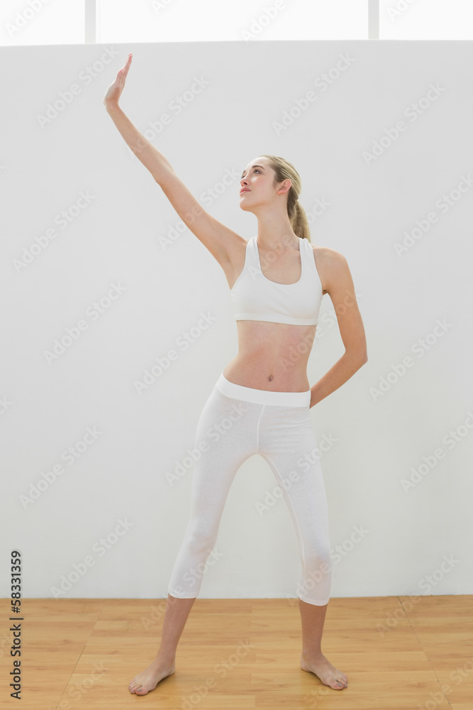 Fototapeta premium Lovely toned woman doing yoga pose for stretching her body