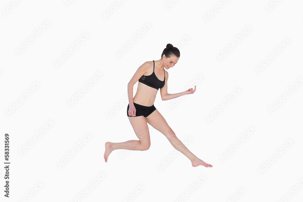 Full length of a sporty young woman jumping Full length of a sporty young woman jumping
