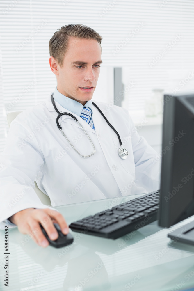 Doctor using computer at medical office Doctor using computer at medical office